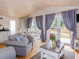A living room with a sofa and table at Typhoon Lodge in Winchester