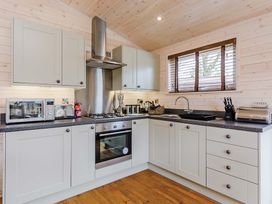 A kitchen with cabinets and appliances at Typhoon Lodge in Winchester