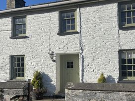A house exterior with windows and a door at Millers Cottage in Newcastle Emlyn