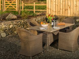 An outdoor dining area with a table and chairs at Millers Cottage in Newcastle Emlyn