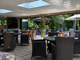 An outdoor dining area with chairs and tables at Millers Cottage Newcastle Emlyn
