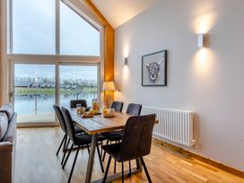 A dining room with a table and chairs at Tranquillity 3 Warton near Carnforth