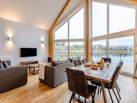 A living room with sofa and dining table at Tranquillity 3 in Warton near Carnforth