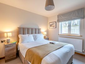 A bedroom with a bed and two bedside tables at Tranquillity 3 in Warton near Carnforth
