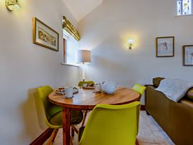 A dining room with a table and chairs at Barley Park in Marhamchurch