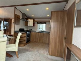 A kitchen with a sink and oven at Wyreside Lakes - Holiday Accommodation 17442, Lancaster