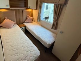 A bedroom with twin beds and a window at Wyreside Lakes - Holiday Accommodation 17442, Lancaster