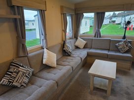 A living room with a sofa and table at Brynowen Holiday Park - Holiday Accommodation 22432 Borth