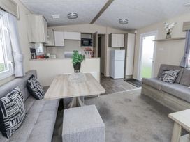 A living room with a sofa and coffee table at Brynowen Holiday Park - Holiday Accommodation 22432 Borth