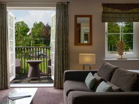 A living room with a sofa and balcony view at Ullswater Apartment in Penrith
