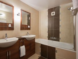 A bathroom with sinks and mirrors at Ullswater Apartment in Penrith