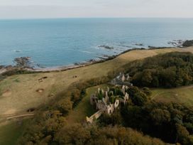 A landscape view of coastal ruins near the ocean at The Weir North Berwick