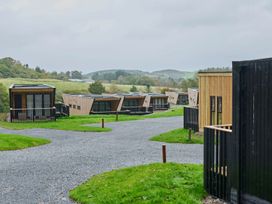 A view of cabins along a path in Orka 1.0 Spa (Pet) Dumfries