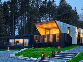 A house with a deck and garden area at Orka 1.0 Spa (Pet) Dumfries