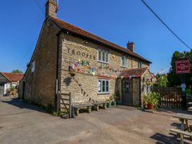 An exterior view of The Trooper Inn with seating outside at The Old Barn in Stourton Caundle near Stalbridge