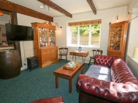 A living room with a sofa and coffee table at The Old Barn in Stourton Caundle near Stalbridge