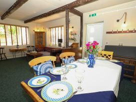 A dining room with a table set for meals at The Old Barn in Stourton Caundle near Stalbridge