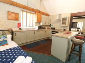 A kitchen with cabinets and a sink at The Old Barn in Stourton Caundle near Stalbridge