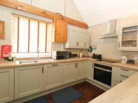 A kitchen with a sink and appliances at The Old Barn in Stourton Caundle near Stalbridge