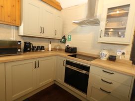 A kitchen with cabinets and appliances at The Old Barn in Stourton Caundle near Stalbridge