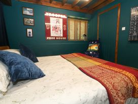 A bedroom with a bed and decorative items at The Old Barn in Stourton Caundle near Stalbridge
