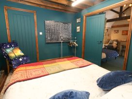 A bedroom with a bed and calendar at The Old Barn in Stourton Caundle near Stalbridge