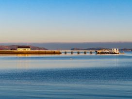 A view of a pier and building by the water at New build at Tyn Pwll in Llanfairpwllgwyngyll