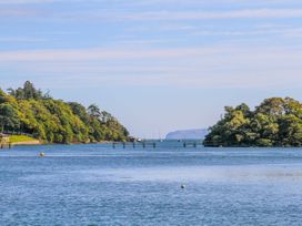 A view of water with trees and a pier at New build at Tyn Pwll in Llanfairpwllgwyngyll