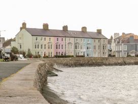 A waterfront view of pastel colored houses at New build at Tyn Pwll in Llanfairpwllgwyngyll