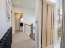 A hallway with doors and a staircase at Pistyll Ddu in Brynsiencyn near Llanfairpwllgwyngyll