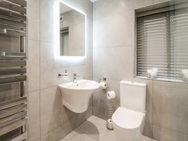 A bathroom with a toilet and a basin at Pistyll Ddu in Brynsiencyn near Llanfairpwllgwyngyll