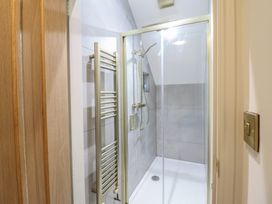 A shower with a towel warmer in a bathroom at Pistyll Ddu in Brynsiencyn near Llanfairpwllgwyngyll