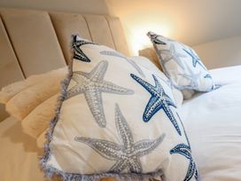 Two decorative pillows on a bed at Pistyll Ddu in Brynsiencyn near Llanfairpwllgwyngyll