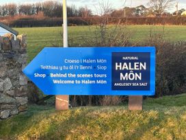 A sign for Halen Môn indicating shop and tours in Anglesey