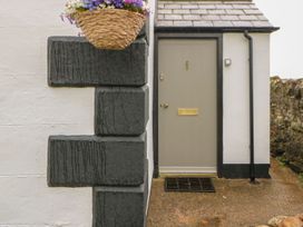 A door with a flower pot above at Orchard Cottage in Appleby-in-Westmorland