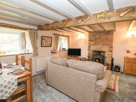 A living room with a sofa and television at Orchard Cottage in Appleby-in-Westmorland