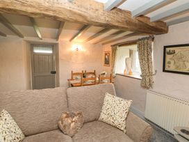 A living room with a sofa and a dining table at Orchard Cottage Appleby-in-Westmorland