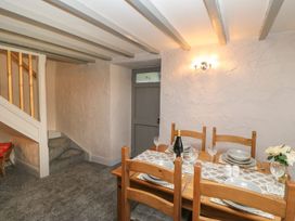 A dining room with a table set for dinner at Orchard Cottage in Appleby-in-Westmorland