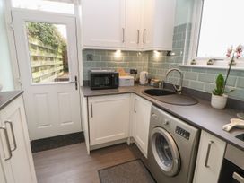 A kitchen with a sink and washing machine at Orchard Cottage in Appleby-in-Westmorland