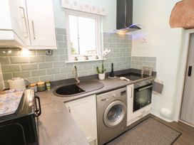 A kitchen with a sink and washing machine at Orchard Cottage in Appleby-in-Westmorland