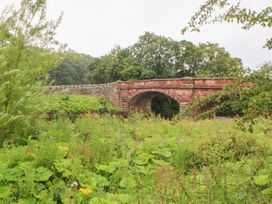 A stone bridge over greenery at Orchard Cottage in Appleby-in-Westmorland