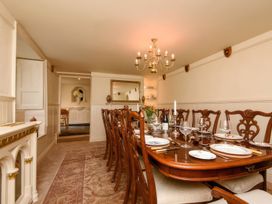 A dining room with a table set for a meal at Ladye Park in Liskeard