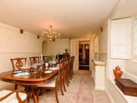 A dining room with a large table set for a meal at Ladye Park in Liskeard