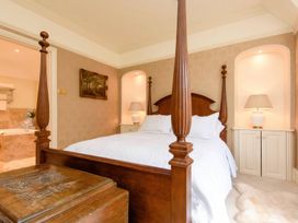 A bedroom featuring a four-poster bed and nightstands at Ladye Park in Liskeard