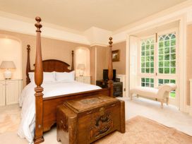 A bedroom with a bed and a chest at Ladye Park in Liskeard