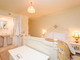 A bedroom with a bed and vanity at Ladye Park in Liskeard