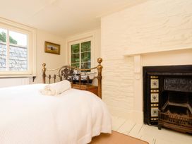 A bedroom with a bed and fireplace at Ladye Park in Liskeard