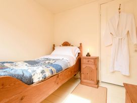 A bedroom with a bed and a nightstand at Ladye Park in Liskeard