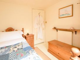 A bedroom with a bed and a chest at Ladye Park in Liskeard