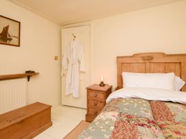 A bedroom with a bed and bedside table at Ladye Park in Liskeard